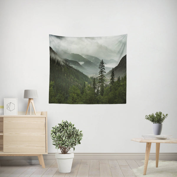50x60 inch Scenic Mountain Wall Tapestry featuring a foggy valley and pine forest surrounded by rolling peaks by Lost in Nature