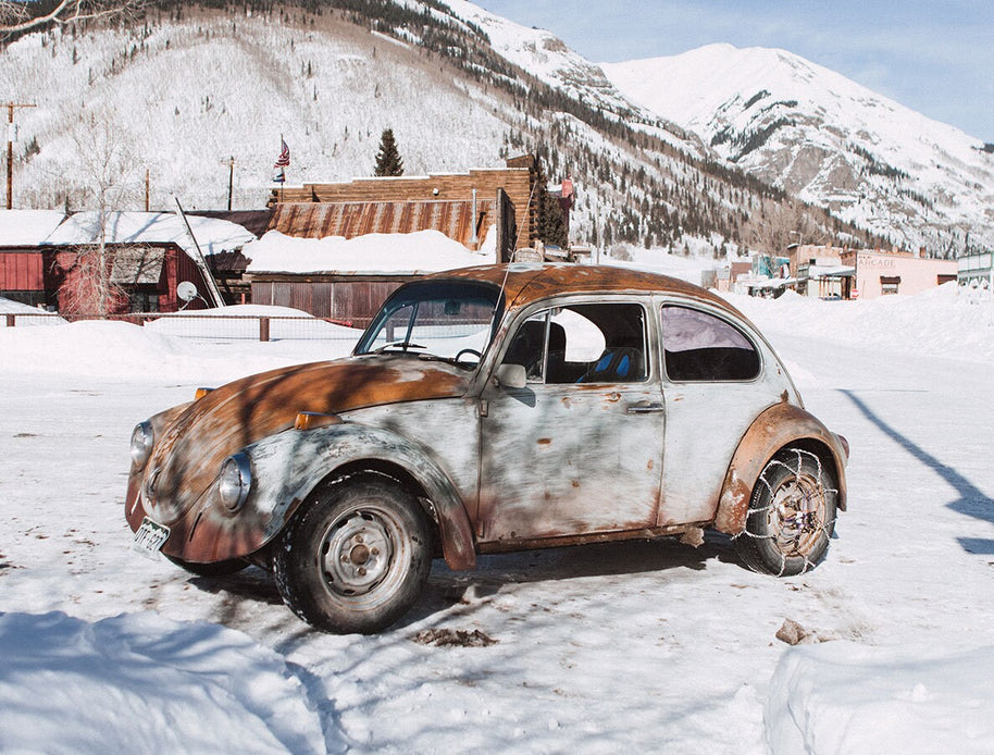 Winter Wonderland Beauty: Scenic Photo of Vintage Beetle in a Quaint Snowy Mountain Village