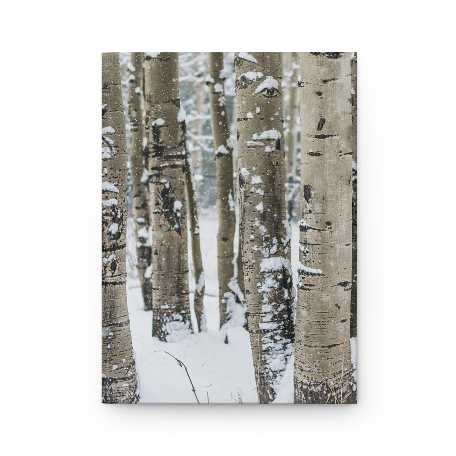 A vertical canvas wall art print depicting a winter forest of birch or aspen trees with snow-covered trunks, shown against a plain white background.