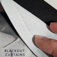 Close-up of a fabric curtain panel with a visible fold seam and a finger pointing to it, with the text 'BLACKOUT CURTAINS' overlaid in the lower left.