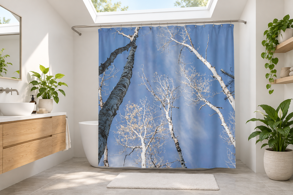 Blue-sky aspen shower curtain in a modern bathroom with a skylight and green plants