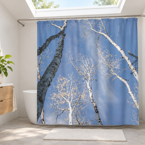 Blue-sky aspen shower curtain in a modern bathroom with a skylight and green plants