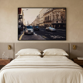 London street photograph framed above a bed in a modern hotel room
