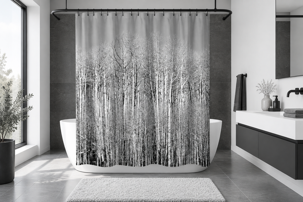 Monochrome forest shower curtain in a modern black, white, and grey bathroom