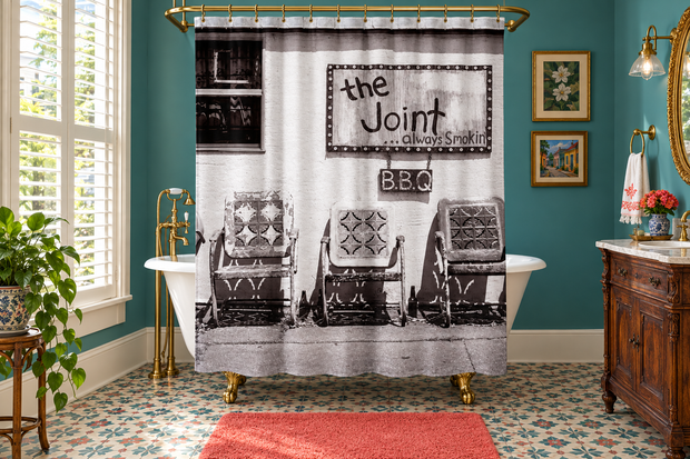 The Joint shower curtain in a colorful New Orleans cottage bathroom