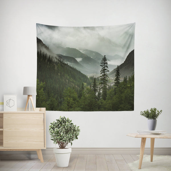 80x68 inch Scenic Mountain Wall Tapestry featuring a foggy valley and pine forest surrounded by rolling peaks by Lost in Nature