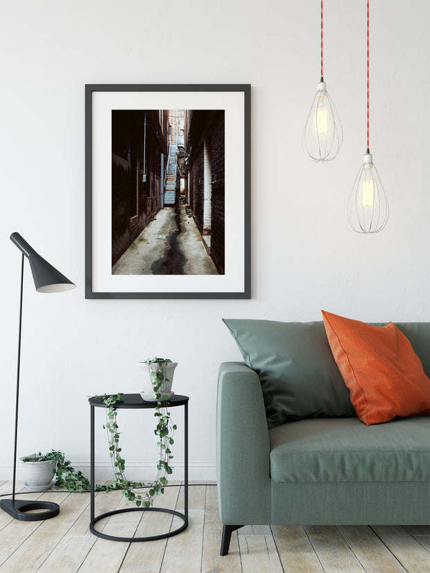 Black-framed grunge alley wall art with narrow shadowy wet alleyway brick walls alabama photo print from birmingham alabama