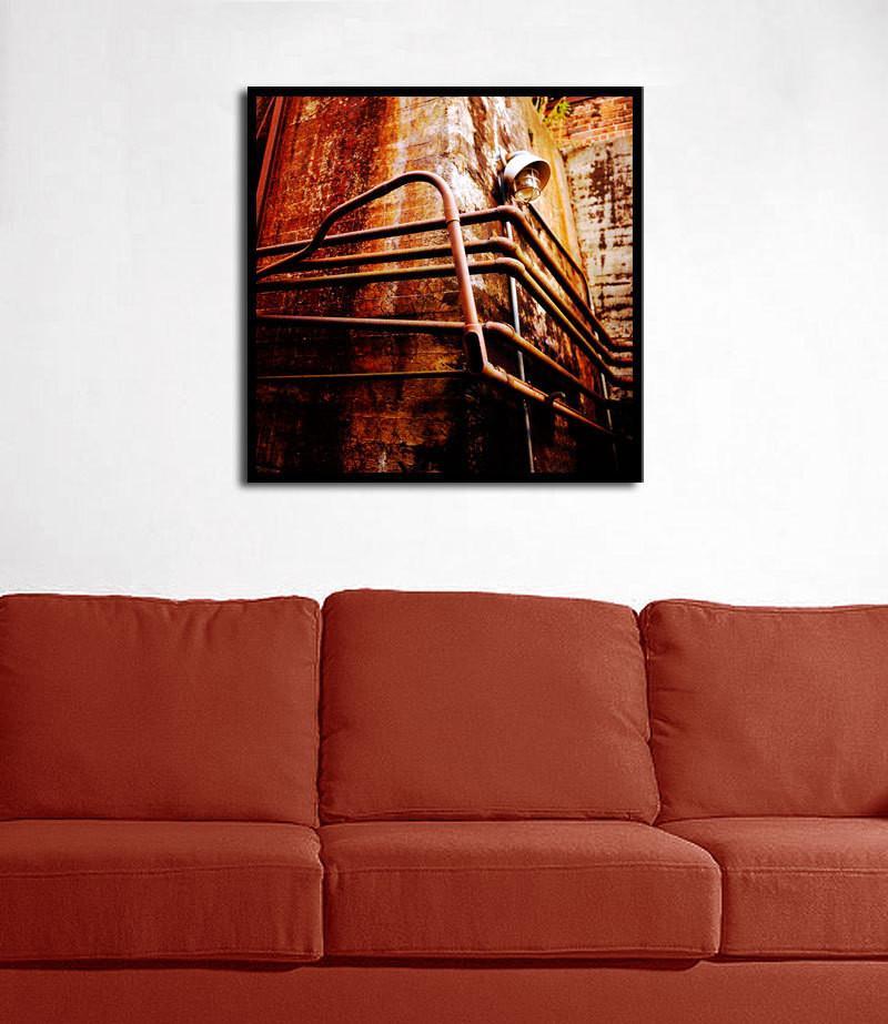Rustic industrial photography canvas print featuring converging pipes and vintage lamp with warm light leaks backdrop