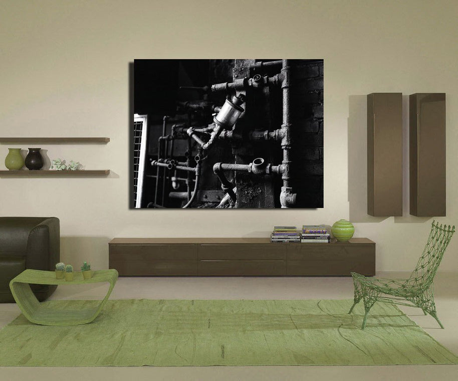 Black-and-white industrial pipe works artwork hanging on wall featuring white industrial photography style details