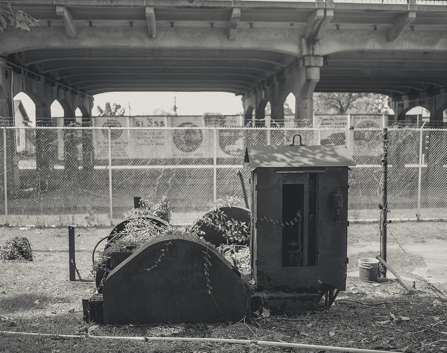 Rusty metal utility box with small roof and door outdoors under overpass in sloss furnaces birmingham alabama photo print
