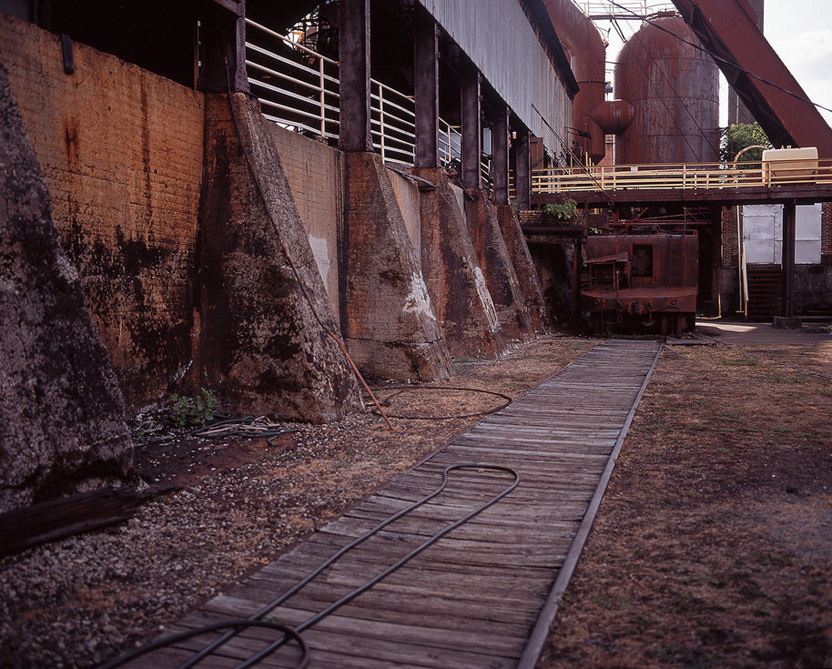 Industrial tracks alabama photo print featuring rusty concrete retaining wall with weathered orange brown patina in birmingham alabama