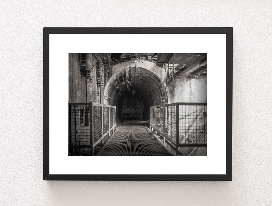 Black-framed black and white photo print of the Sloss Tunnel with metal grating in birmingham alabama